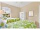 Bedroom with two twin beds, natural light, and views at 11492 Dancing River Dr, Venice, FL 34292