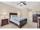 Comfortable bedroom with a ceiling fan and dark wood furniture at 11492 Dancing River Dr, Venice, FL 34292