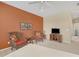 Comfortable bedroom with wicker chairs, side tables, and decorative bicycle art at 11492 Dancing River Dr, Venice, FL 34292
