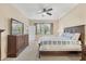 Comfortable bedroom with a ceiling fan and dark wood furniture at 11492 Dancing River Dr, Venice, FL 34292