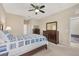 Comfortable bedroom with a ceiling fan and dark wood furniture at 11492 Dancing River Dr, Venice, FL 34292