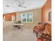 Large bonus room with ceiling fan features a desk and comfortable seating at 11492 Dancing River Dr, Venice, FL 34292