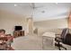 Large bonus room with ceiling fan features a desk and comfortable seating at 11492 Dancing River Dr, Venice, FL 34292