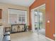 Cozy dining area features a large window, slider to the lanai, and a console table at 11492 Dancing River Dr, Venice, FL 34292