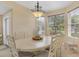 Bright dining room features an elegant chandelier and large windows overlooking the manicured lawn at 11492 Dancing River Dr, Venice, FL 34292
