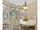 Bright dining room features an elegant chandelier and large windows overlooking the manicured lawn at 11492 Dancing River Dr, Venice, FL 34292