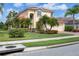 Lovely two-story home with a red tile roof, lush landscaping, and a well-maintained lawn at 11492 Dancing River Dr, Venice, FL 34292