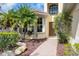 Inviting front entrance with stone walkway and lush landscaping leading to the front door at 11492 Dancing River Dr, Venice, FL 34292