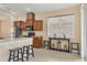 Open kitchen features wood cabinetry, stainless steel appliances, breakfast bar, and view to the dining area at 11492 Dancing River Dr, Venice, FL 34292