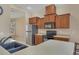 Well-equipped kitchen with wood cabinetry, stainless steel appliances, and ample counter space for meal preparation at 11492 Dancing River Dr, Venice, FL 34292