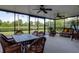 Spacious screened porch with ceiling fans and water view, ideal for outdoor relaxation and entertaining at 11492 Dancing River Dr, Venice, FL 34292