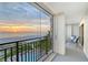 Balcony view of pool, beach, and ocean at sunset at 20 Whispering Sands Dr # 501, Sarasota, FL 34242