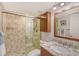 Bathroom with tiled shower, modern fixtures, granite countertop, and ample storage at 20 Whispering Sands Dr # 501, Sarasota, FL 34242