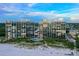 Exterior view of beachfront condos with pool, offering stunning views and beachfront living at 20 Whispering Sands Dr # 501, Sarasota, FL 34242