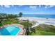 Stunning overhead view of a community pool near the beach, surrounded by lush landscaping at 20 Whispering Sands Dr # 501, Sarasota, FL 34242