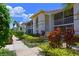 Charming condo exterior features lovely landscaping, sidewalks, screened balconies, and a bright, white facade at 6904 Drewrys Blf # 803, Bradenton, FL 34203