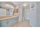 Bathroom with light blue vanity, large mirror, and tiled floor at 4126 Central Sarasota Pkwy # 2026, Sarasota, FL 34238