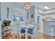 White round table with blue chairs and view into kitchen at 4126 Central Sarasota Pkwy # 2026, Sarasota, FL 34238