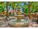 Ornate tiered fountain in a lush garden setting at 4126 Central Sarasota Pkwy # 2026, Sarasota, FL 34238