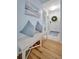 Light and airy entryway with a bench, showcasing light wood floors at 4126 Central Sarasota Pkwy # 2026, Sarasota, FL 34238