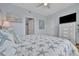 Main bedroom with king-size bed, dresser, and large TV at 4126 Central Sarasota Pkwy # 2026, Sarasota, FL 34238