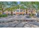 Exterior view of a building with parking and lush landscaping at 4126 Central Sarasota Pkwy # 2026, Sarasota, FL 34238