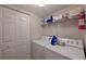 Convenient laundry room with washer, dryer, and ample storage shelving at 6904 Drewrys Blf # 803, Bradenton, FL 34203