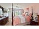 Spacious bedroom with a post bed, and large window overlooking the golf course at 6904 Drewrys Blf # 803, Bradenton, FL 34203