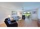 Living room with sliding doors to patio, hardwood floors, and comfortable furniture at 6904 Drewrys Blf # 803, Bradenton, FL 34203