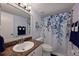 Updated bathroom with granite countertop, white vanity, and a shower with a patterned curtain at 6904 Drewrys Blf # 803, Bradenton, FL 34203