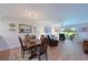 Bright dining room with wood table and chairs, hardwood floors, and view to living room at 6904 Drewrys Blf # 803, Bradenton, FL 34203