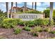 Community entrance with landscaped grounds and signage at 7365 Regina Royale Blvd # 10, Sarasota, FL 34238