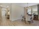 Bright dining room features a round table and chairs, hardwood floors, and an elegant chandelier at 918 Fernleaf Run, Bradenton, FL 34212