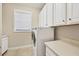 Laundry room with washer, dryer, and white cabinets at 5234 Castello Ln, Lakewood Ranch, FL 34211