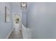 Bright hallway with light gray walls and white railings leading upstairs at 4001 Gulf Dr # 111, Holmes Beach, FL 34217