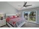 Main bedroom with water views, king bed, and ceiling fan at 4001 Gulf Dr # 111, Holmes Beach, FL 34217