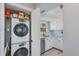 Compact laundry closet with stacked washer and dryer, offers convenient in-unit laundry at 4001 Gulf Dr # 111, Holmes Beach, FL 34217