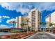 Condo building exterior with palm trees and parking at 20 Whispering Sands Dr # 501, Sarasota, FL 34242