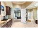 Well-equipped coffee bar with granite countertops, dark wood cabinets, and convenient access to the bedroom at 3218 Signet Ct, Sarasota, FL 34240
