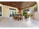 Spacious covered patio with fireplace, dining area, and seating at 3218 Signet Ct, Sarasota, FL 34240