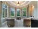 Bright sitting room with large windows, comfortable seating, and views of the backyard at 3218 Signet Ct, Sarasota, FL 34240