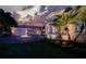 Two-story home with a three-car garage and landscaping at 3218 Signet Ct, Sarasota, FL 34240