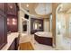 Elegant bathroom with soaking tub, double vanity, and walk-in shower at 3218 Signet Ct, Sarasota, FL 34240