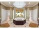 Primary bathroom with large soaking tub, double vanities, and a walk-in shower at 3218 Signet Ct, Sarasota, FL 34240