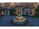 Elegant home entrance with fountain at night at 3218 Signet Ct, Sarasota, FL 34240