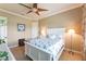 Bright bedroom with a queen bed, ceiling fan and plenty of natural light at 3218 Signet Ct, Sarasota, FL 34240