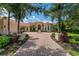 Grand estate home with tile roof, fountain, and landscaped entry at 3218 Signet Ct, Sarasota, FL 34240
