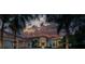 Luxury home exterior at dusk with fountain and landscaping at 3218 Signet Ct, Sarasota, FL 34240