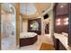 Opulent bathroom boasting a large soaking tub, double vanity, and marble floors at 3218 Signet Ct, Sarasota, FL 34240