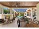 Relaxing enclosed patio with pool view, fireplace, and seating at 3218 Signet Ct, Sarasota, FL 34240